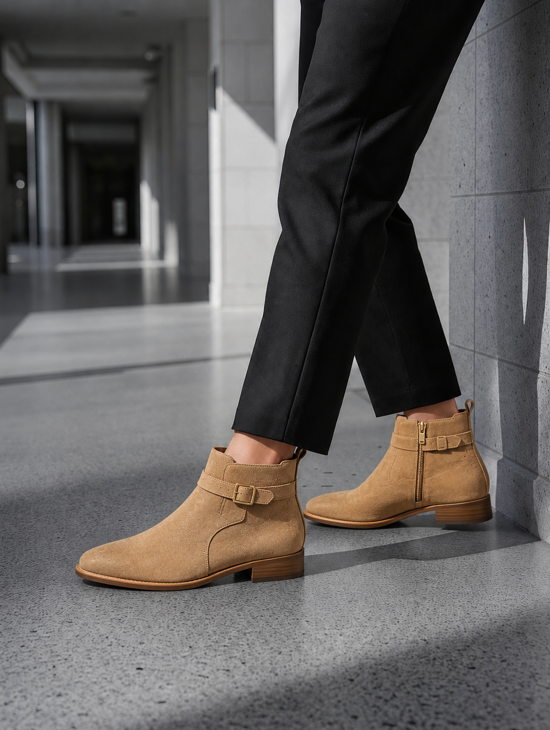 Tan ankle boots worn with black pants in an indoor setting